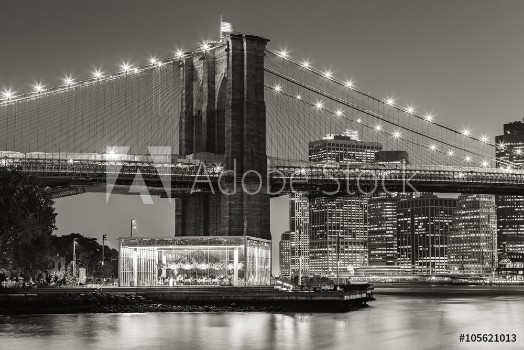 Picture of Black and White of Brooklyn Bridge Tower at twilight with carousel and skyscrapers of Lower Manhattan Financial District New York City